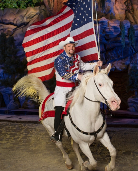 person holding American flag on horse