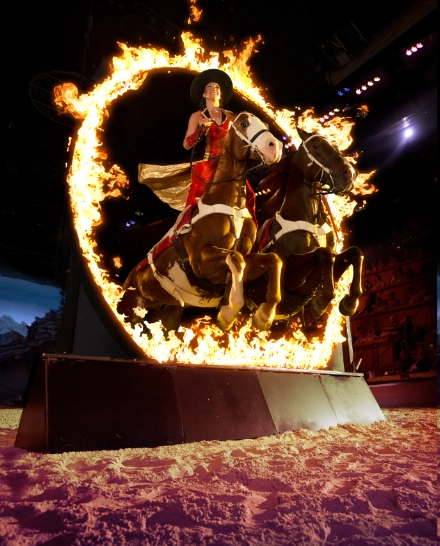 tricker rider on horse through fire ring