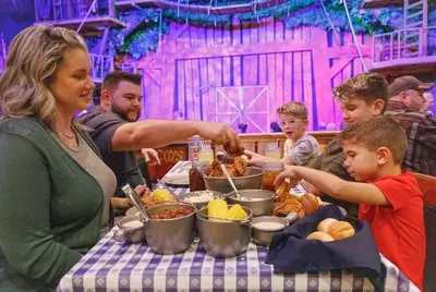 family enjoying the feast at Hatfield and McCoy Dinner Feud